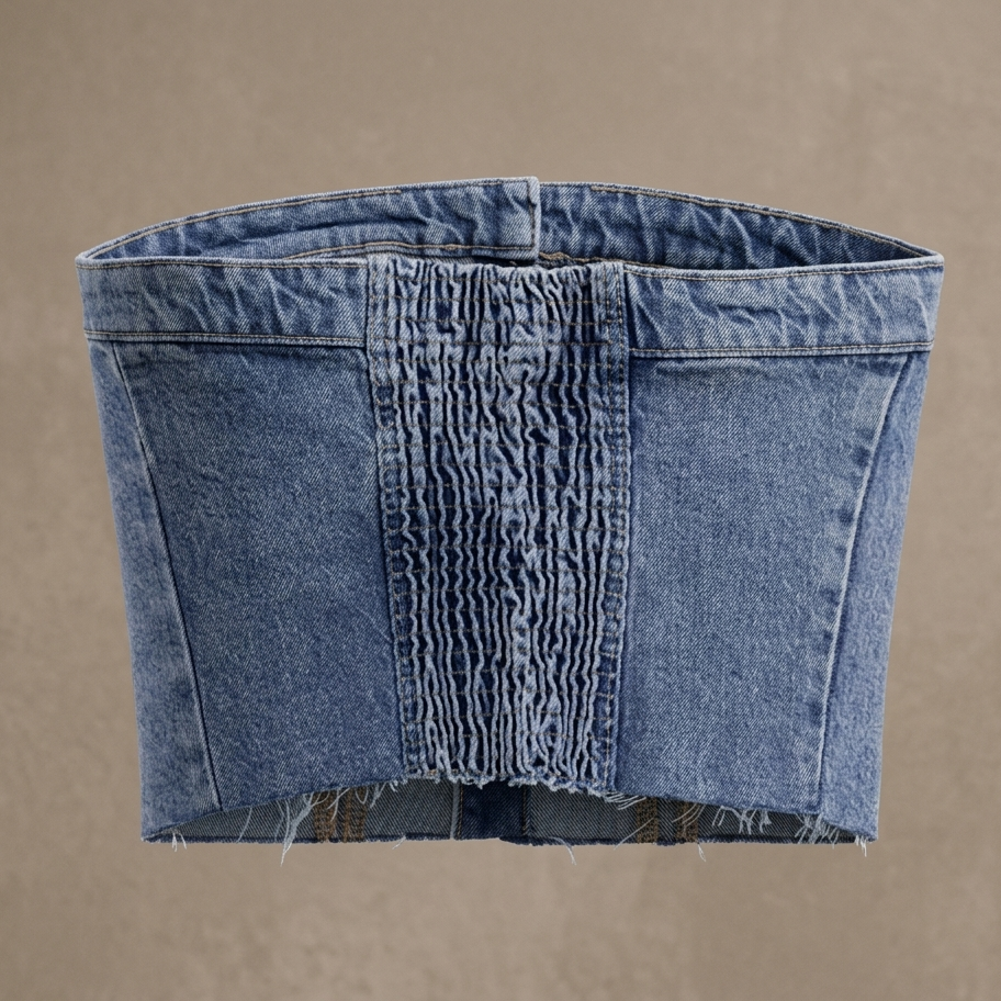 Blue denim top with frayed hem on a beige background