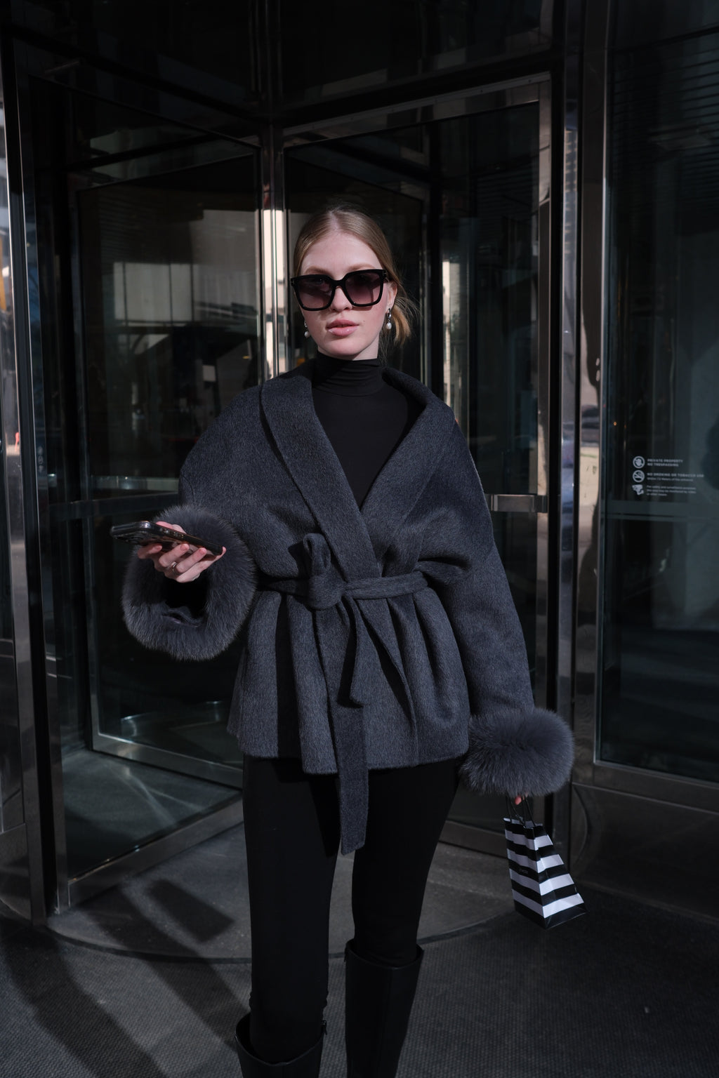Women's luxury charcoal wool coat with genuine rabbit fur cuffs, wrap silhouette, waist belt and elegant winter outerwear design.