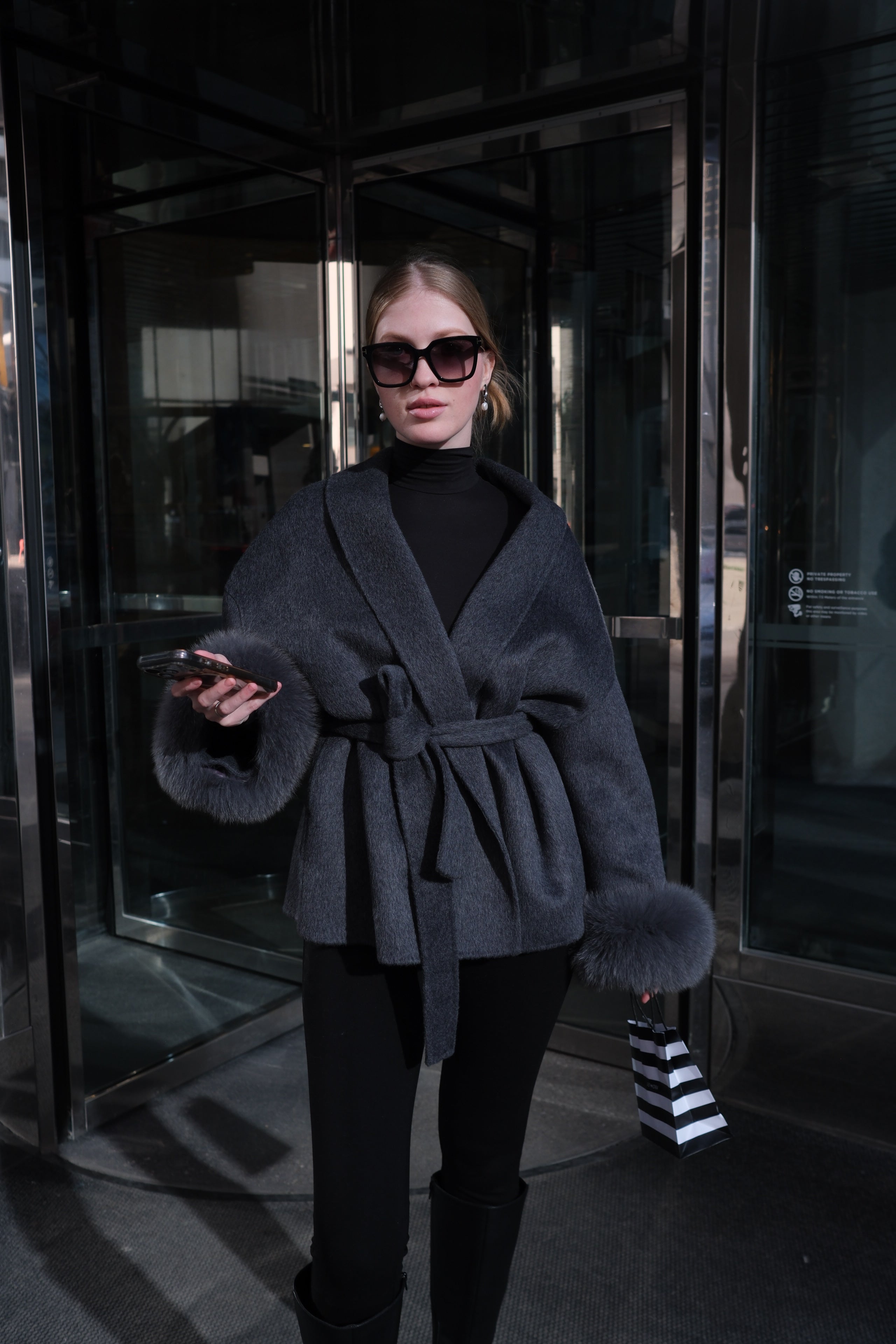 Women's luxury charcoal wool coat with genuine rabbit fur cuffs, wrap silhouette, waist belt and elegant winter outerwear design.