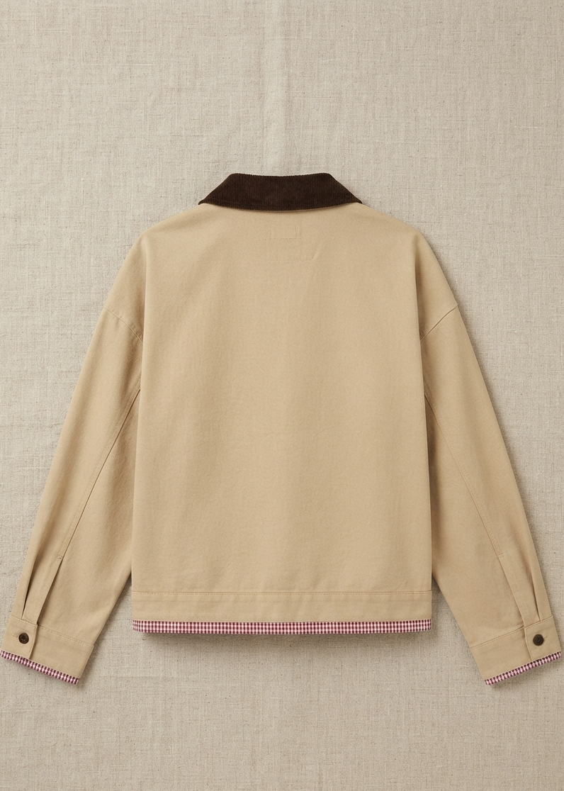 A beige long-sleeve jacket shown from the back, featuring a dark brown collar and a pink and white gingham checkered hem, laid flat on a textured beige fabric background.