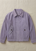 A light purple corduroy jacket with a zippered front, pointed collar, and two buttoned flap pockets, laid flat on a textured beige fabric background.
