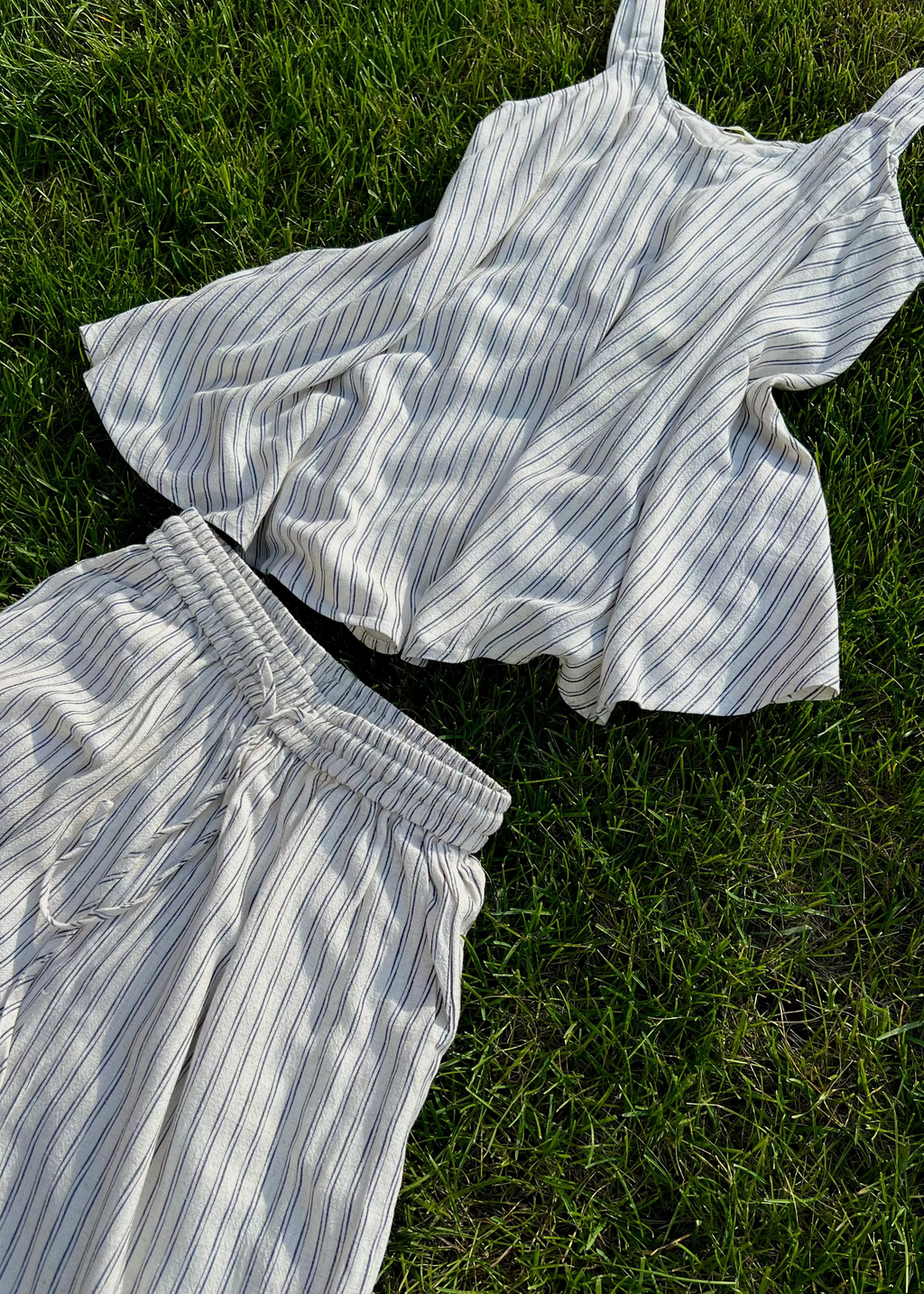 Striped shirt and pants on grass