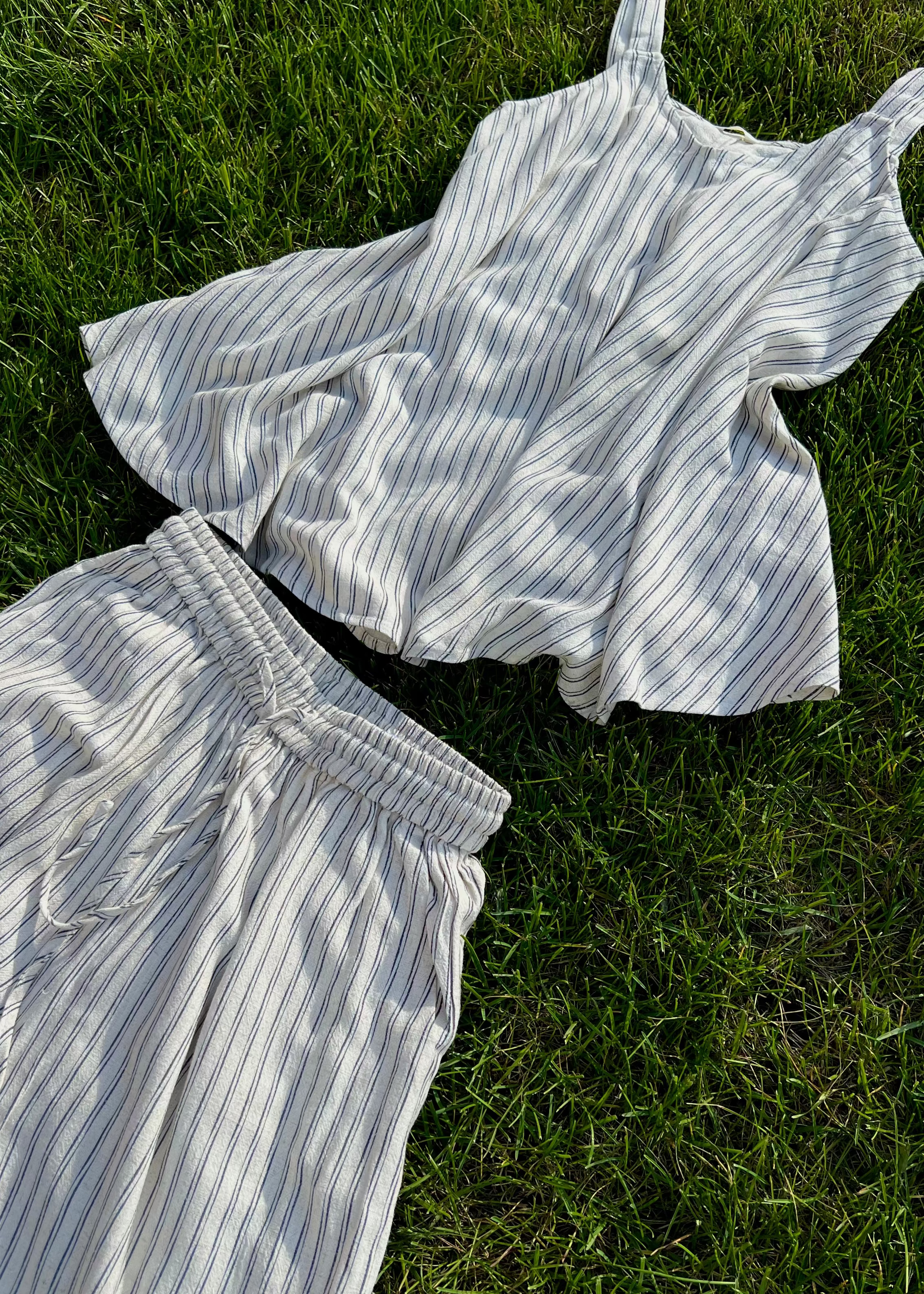 Striped shirt and pants on grass