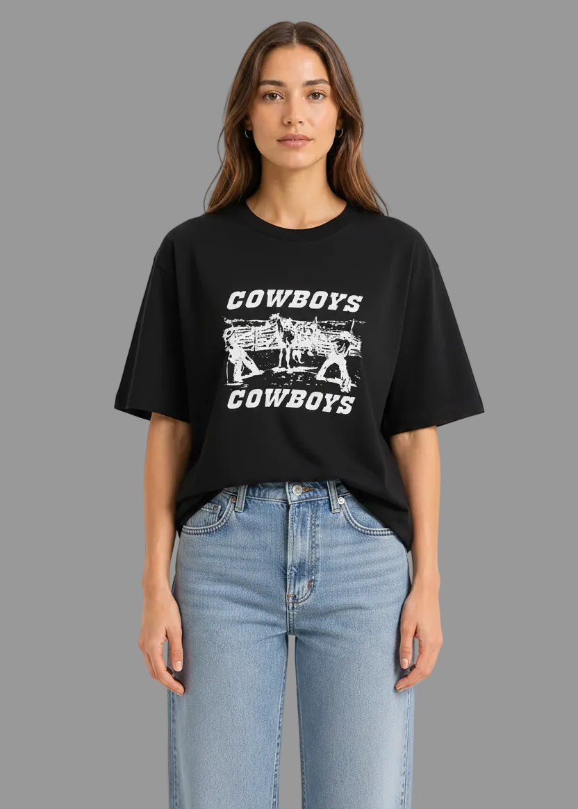 Person wearing a navy blue t-shirt with 'Cowboys' graphic design on a white background