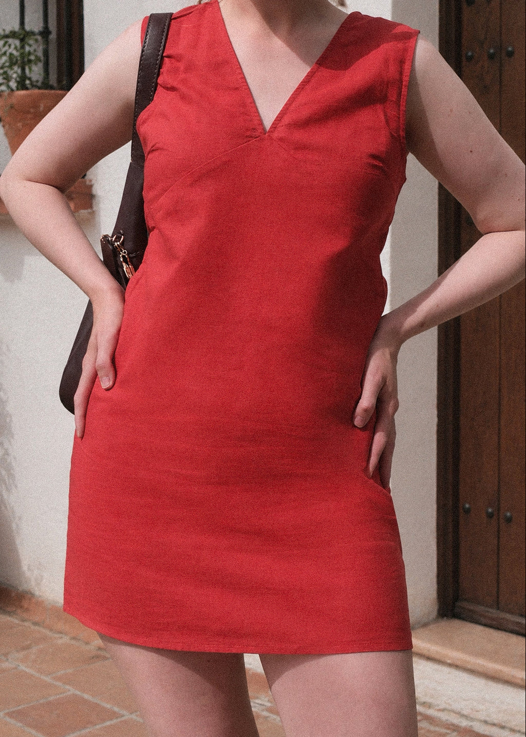 Person wearing a red dress with a blurred background