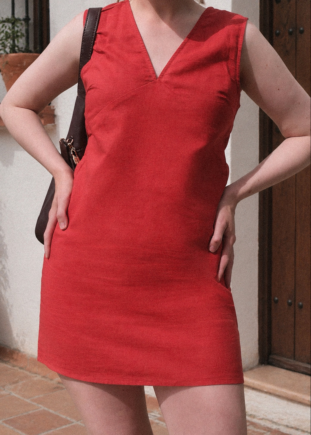 Person wearing a red dress with a blurred background