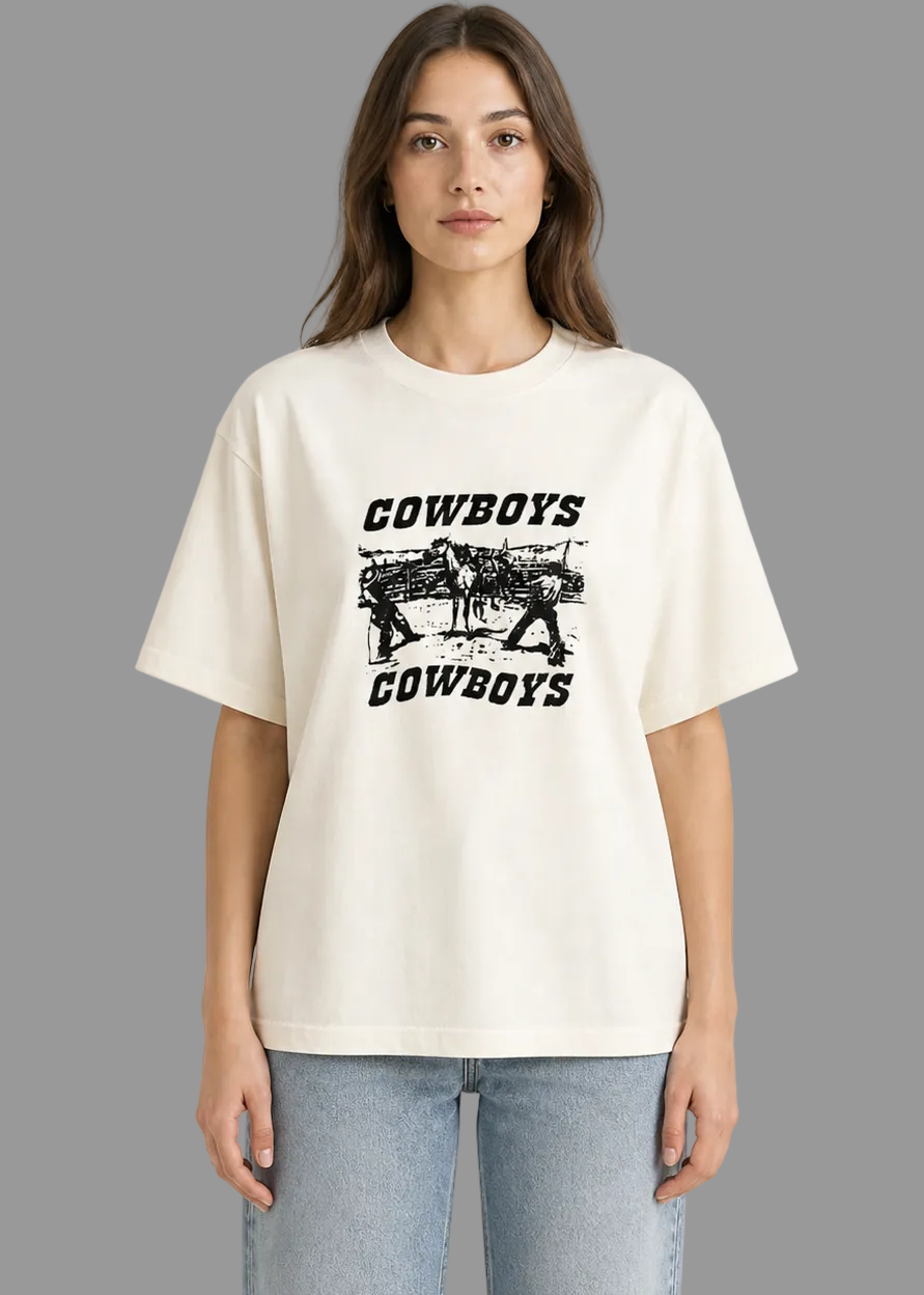 Person wearing a white t-shirt with 'Cowboys' graphic design on a white background