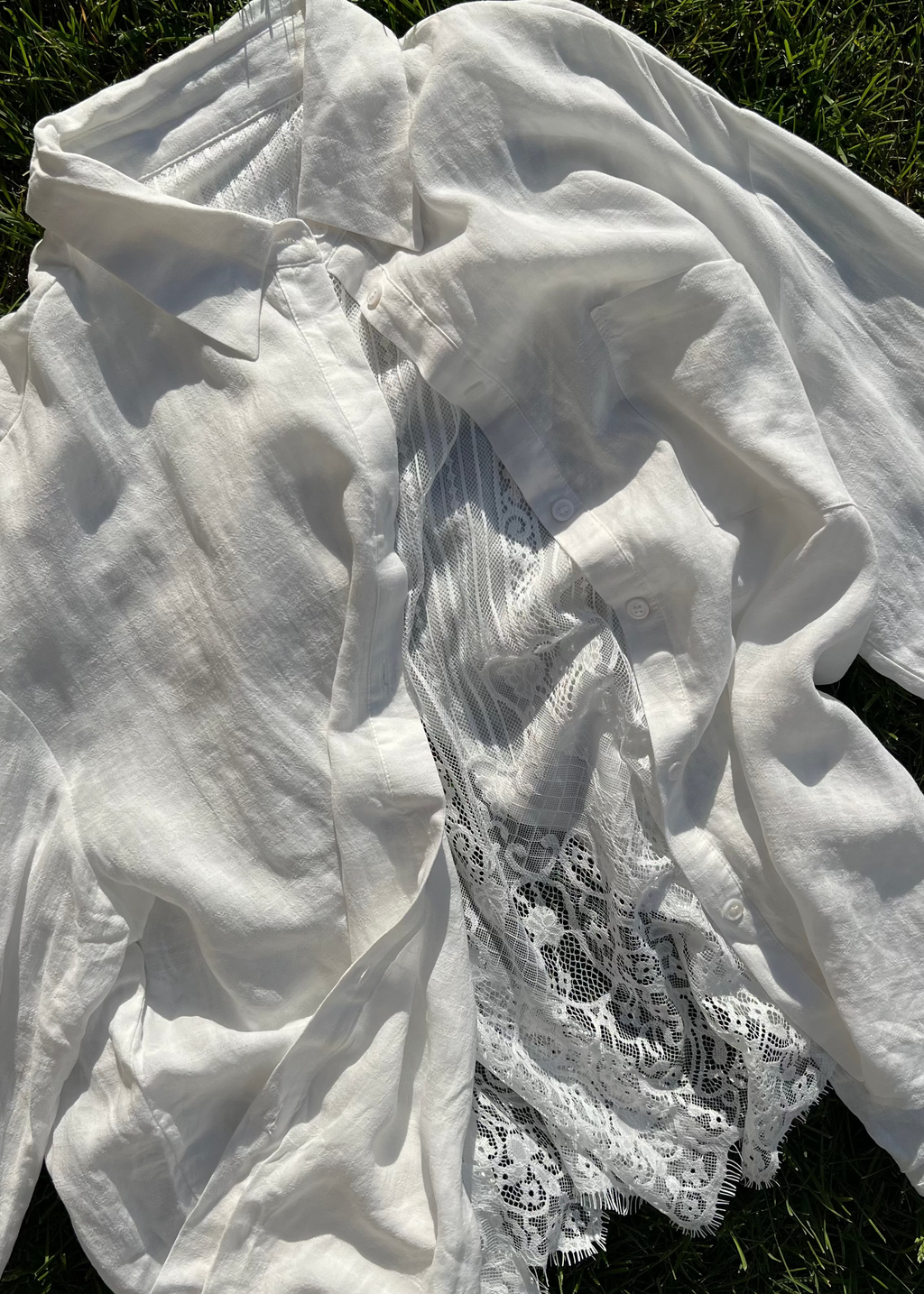 White fabric with lace detailing on a grassy background