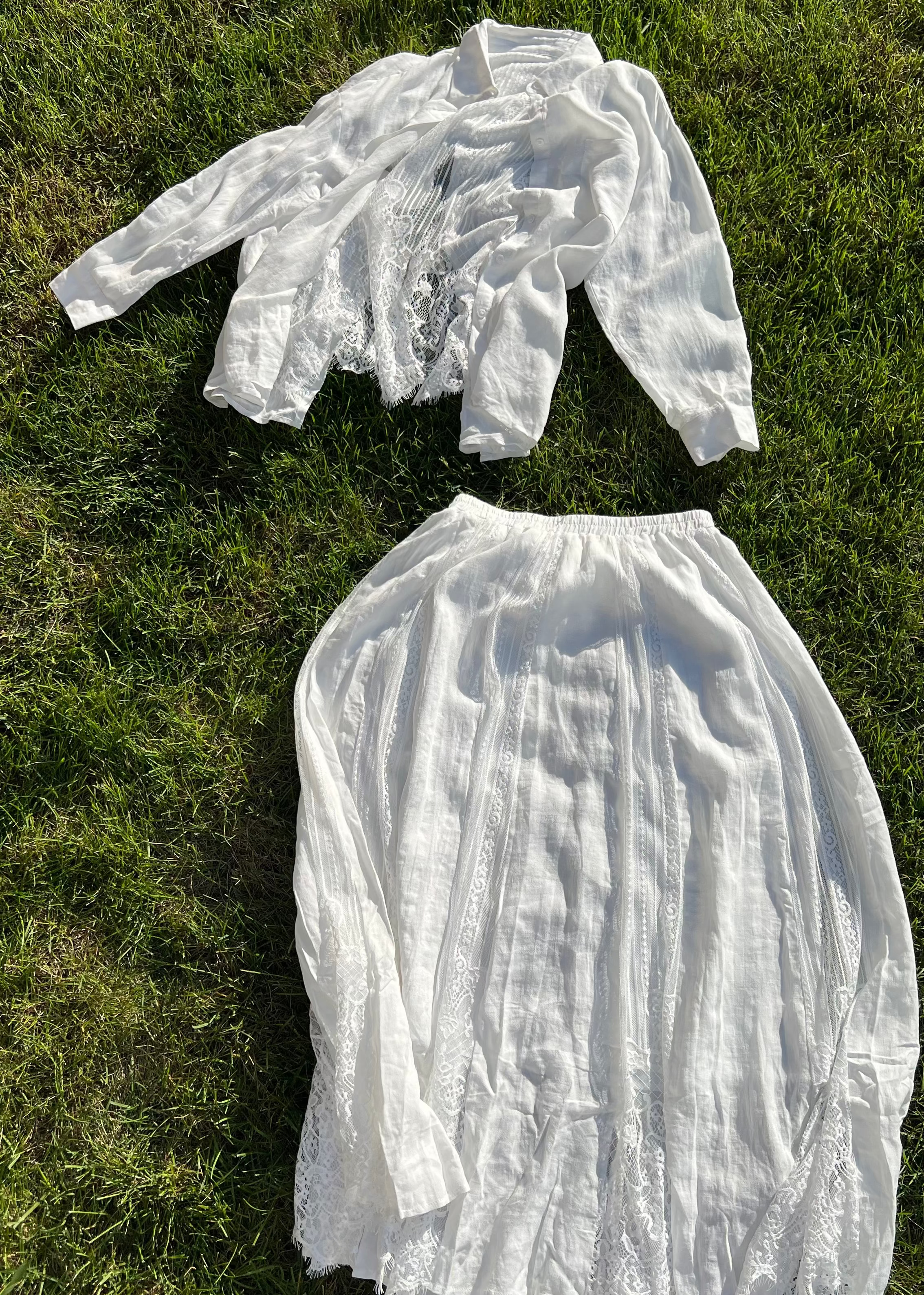 White lace top and skirt set on grass