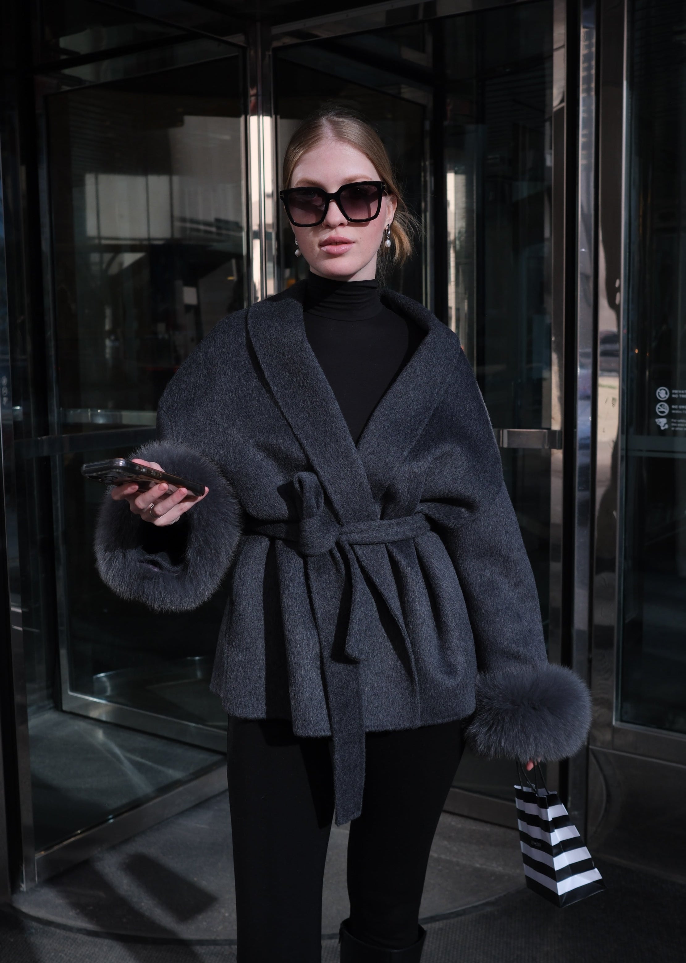 Women's luxury charcoal wool coat with genuine rabbit fur cuffs, wrap silhouette, waist belt and elegant winter outerwear design.