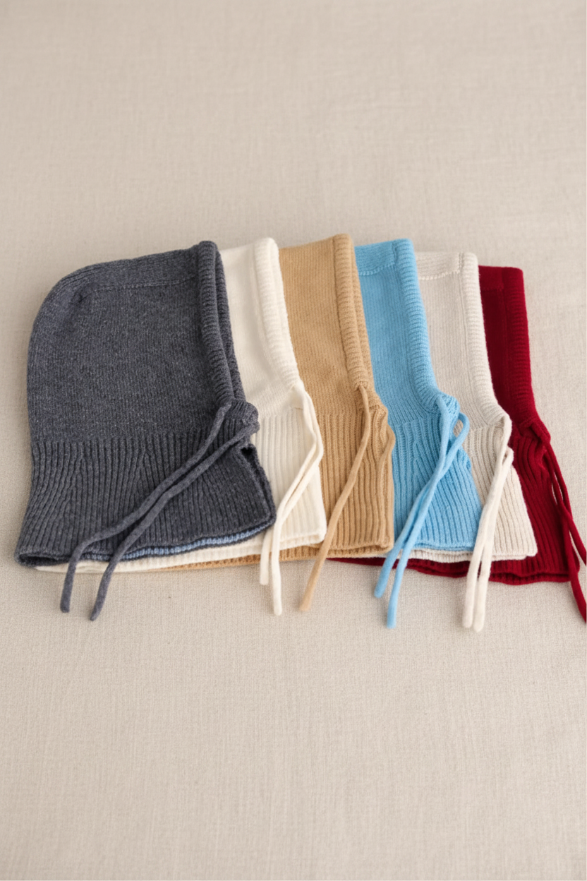 Set of colorful knitted wool hoods on a white background