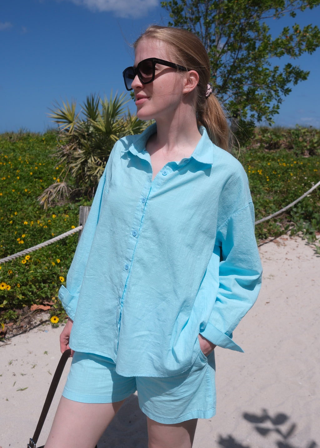 Person wearing a light blue dress with a blurred background