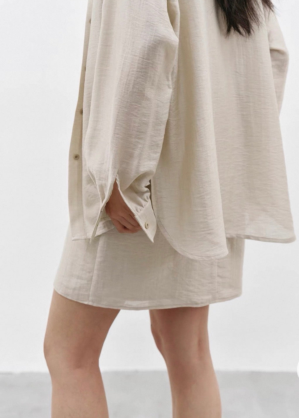 Beige dress worn by a person on a white background